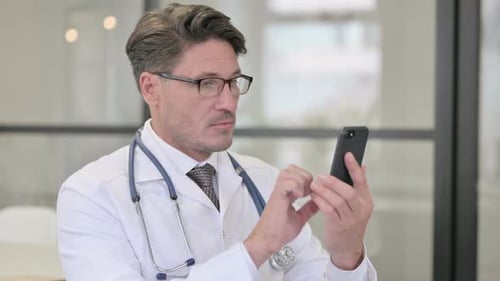 Doctor Using Smartphone for Medical Communication