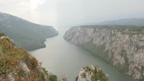 Slow tilt on river Danube gorge between Serbia and Romania 4K 2160p 30fps UltraHD footage - Narrowes