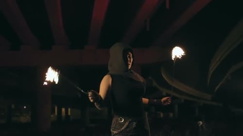 Woman Performing Fire Dance at Night