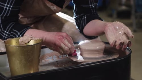 Adult Forming Pottery with Clay on Wheel