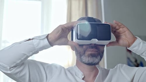 Man Experiencing Virtual Reality Headset at Home