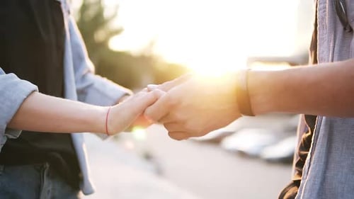 Close Up Footage of Young Couple Holding Hands Having Date in the Park