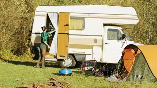 Young Couple Camping Next to an RV