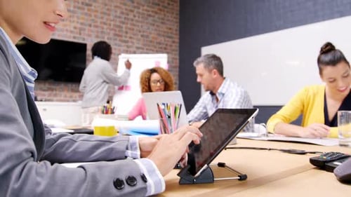 Female business executive using digital tablet in office