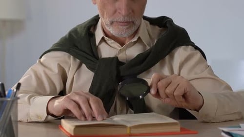 Senior Man Reading with Magnifying Glass
