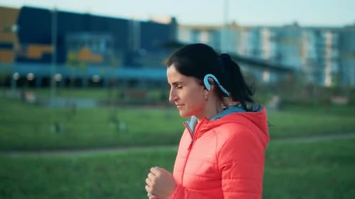 Fitness Young Woman Jogging in the City Park