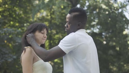 Loving Couple Embracing in a Green Park