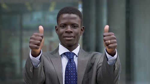 Happy Young Adult Businessman Gives Two Thumbs Up