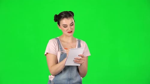 Woman Writing in Notebook on Green Screen