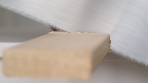 Man Sawing Wooden Plank with Hand Manual Saw