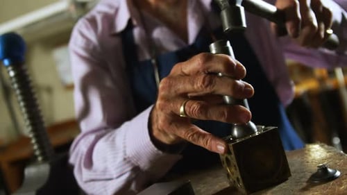 Goldsmith working in workshop