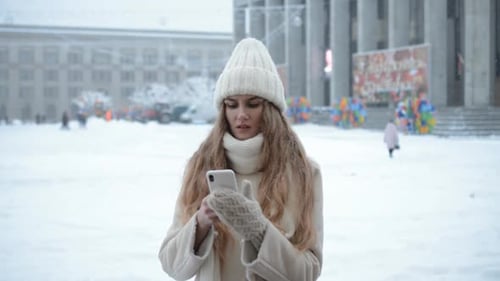 Beautiful Girl Writes a Message on the Phone