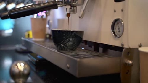 Espresso Pouring From Espresso Machine Into Cup