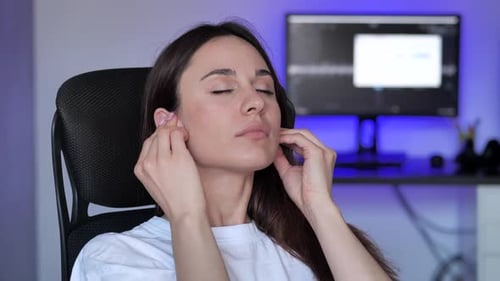 Woman Putting in Wireless Headphones, Eyes Closed, Smiling