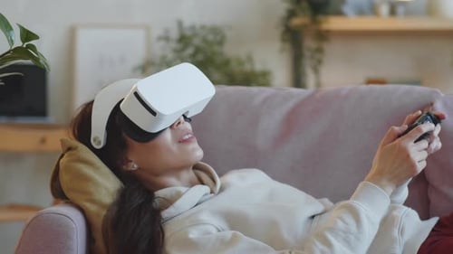 Woman Playing VR Game on Couch at Home