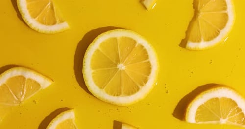 Top view rotation of fresh slice of lemons juice and gel serum