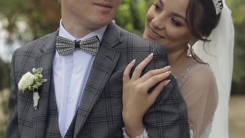 Newlyweds. Caucasian Groom with Bride Walking, Embracing, Hugs in Park. Wedding Couple