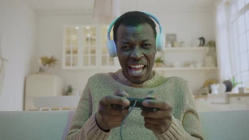 Young Adult Playing Video Game at Home