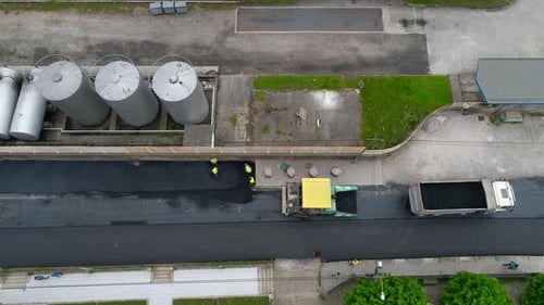 Aerial View of Road Construction Workers Applying Asphalt