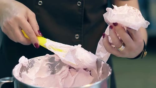Confectioner Fills Plastic Pastry Bag with White Thick Cream