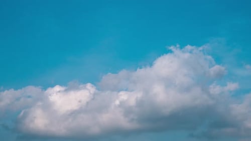 White Clouds Drifting Across Azure Blue Sky