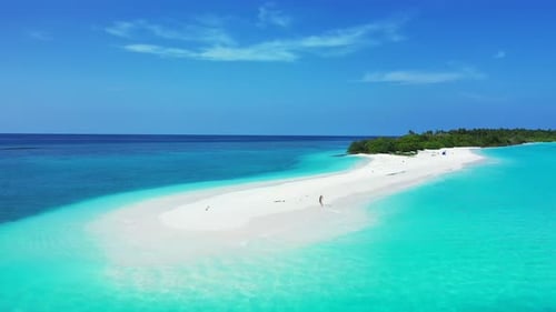 Daytime overhead copy space shot of a sunshine white sandy paradise beach and aqua blue water backgr
