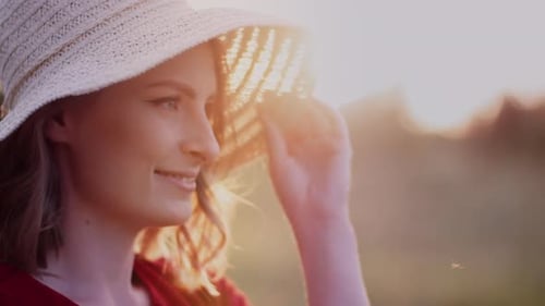 Smiling Woman in Straw Hat in Golden Sunlight