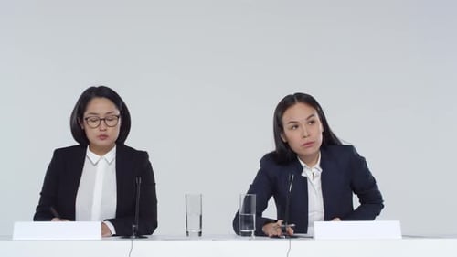 Women at Corporate Presentation Taking Notes