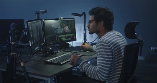 Man Video Editing at Computer Workstation