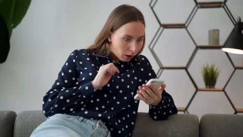 Woman Reacts With Shock to Content on Smartphone