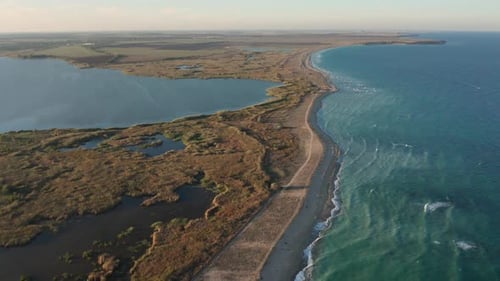 Aerial fly over beautiful empty endless wild beach