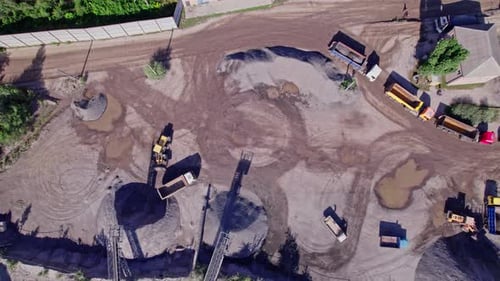 Aerial View of Trucks and Machinery at Industrial Site