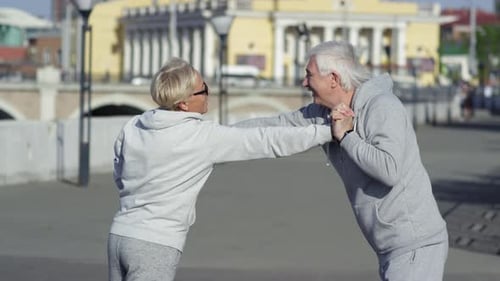 Seniors Exercising Arms Outdoors