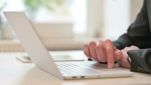 Close Up of Hands of Middle Aged Businessman Using Laptop