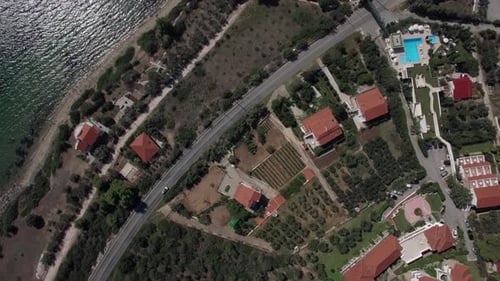 Flying Over the Cottages on Seafront of Trikorfo Beach, Greece