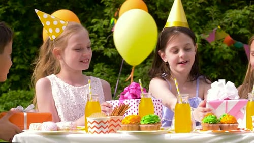 Children Enjoying a Birthday Party in a Garden