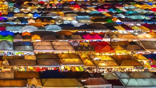 day to night time lapse of Train Night Market Ratchada (Talad Rot Fai) at night in Bangkok, Thailand