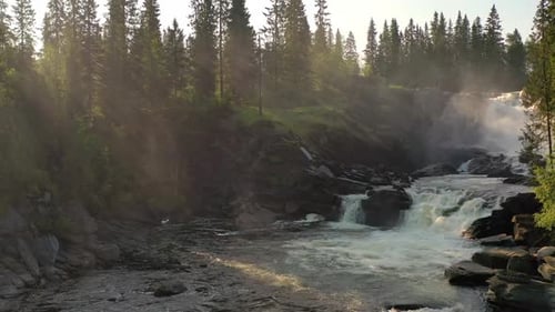 Scenic Waterfall in a Forest With Sunlight