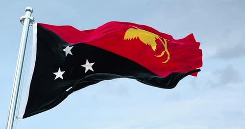 Papua New Guinea Flag Waving Seamlessly with Blue Sky