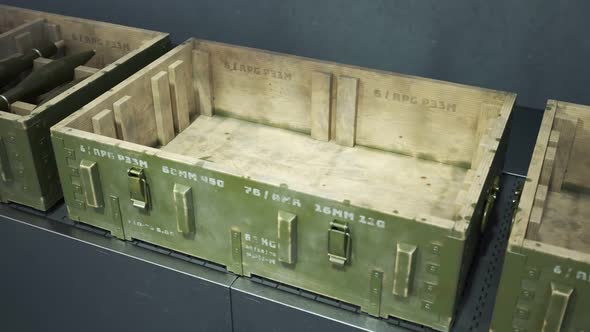 Robot packing military boxes with RPG missiles. Packing line. Warehouse ...