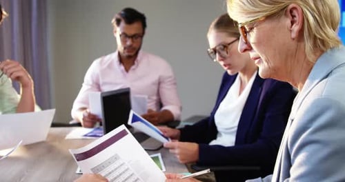 Team Collaborating on Documents in Office Setting