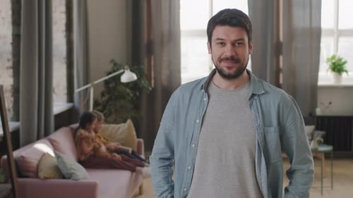 Smiling Man Poses at Home with Children