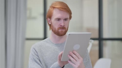 Adult Man Using Tablet Device at Home