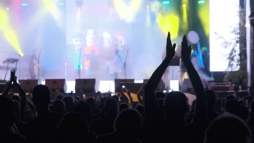 Crowd of Fans at Live Rock Concert Raise Hands and Dance. Slow Motion 240 Fps