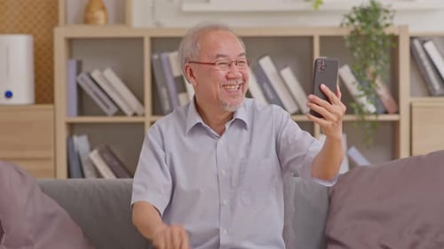 Happy Senior Man Video Calling on Smartphone