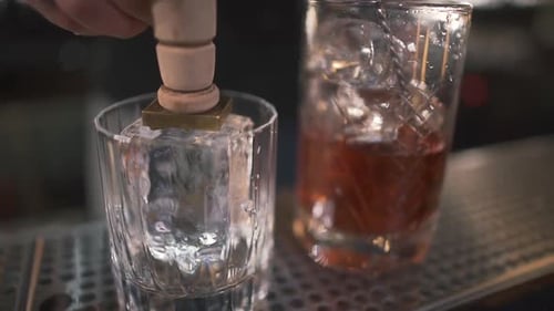 Crafting a Cocktail with Stamped Ice at the Bar