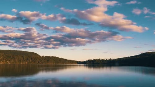 Dramatisch Zeitraffer der Wolken über dem leeren See während der Goldenen Stunde