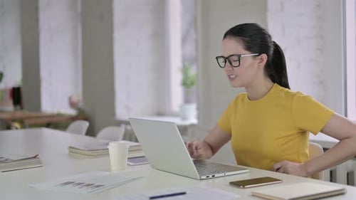 Tired Young Female Designer Having Back Pain in Modern Office