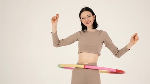 Woman Exercising with Hula Hoop in Home Studio