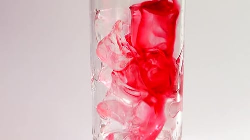 Adding Ice Cubes, Red Juice To a Glass